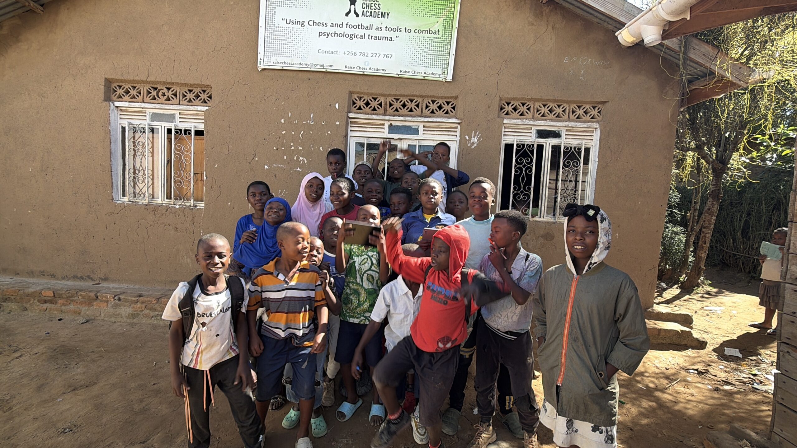 Children at Arise holding the chess-loaded tablets
